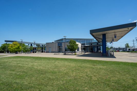 Exterior view of Niagara Falls Transportation center showing a bus to the left and landscaping.